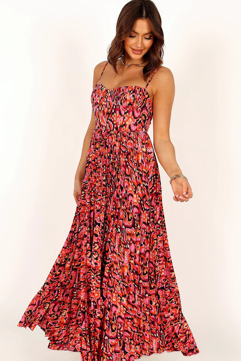 Close-up detail of a pink pink multi pleated maxi dress, showing the fit and drape of the skirt