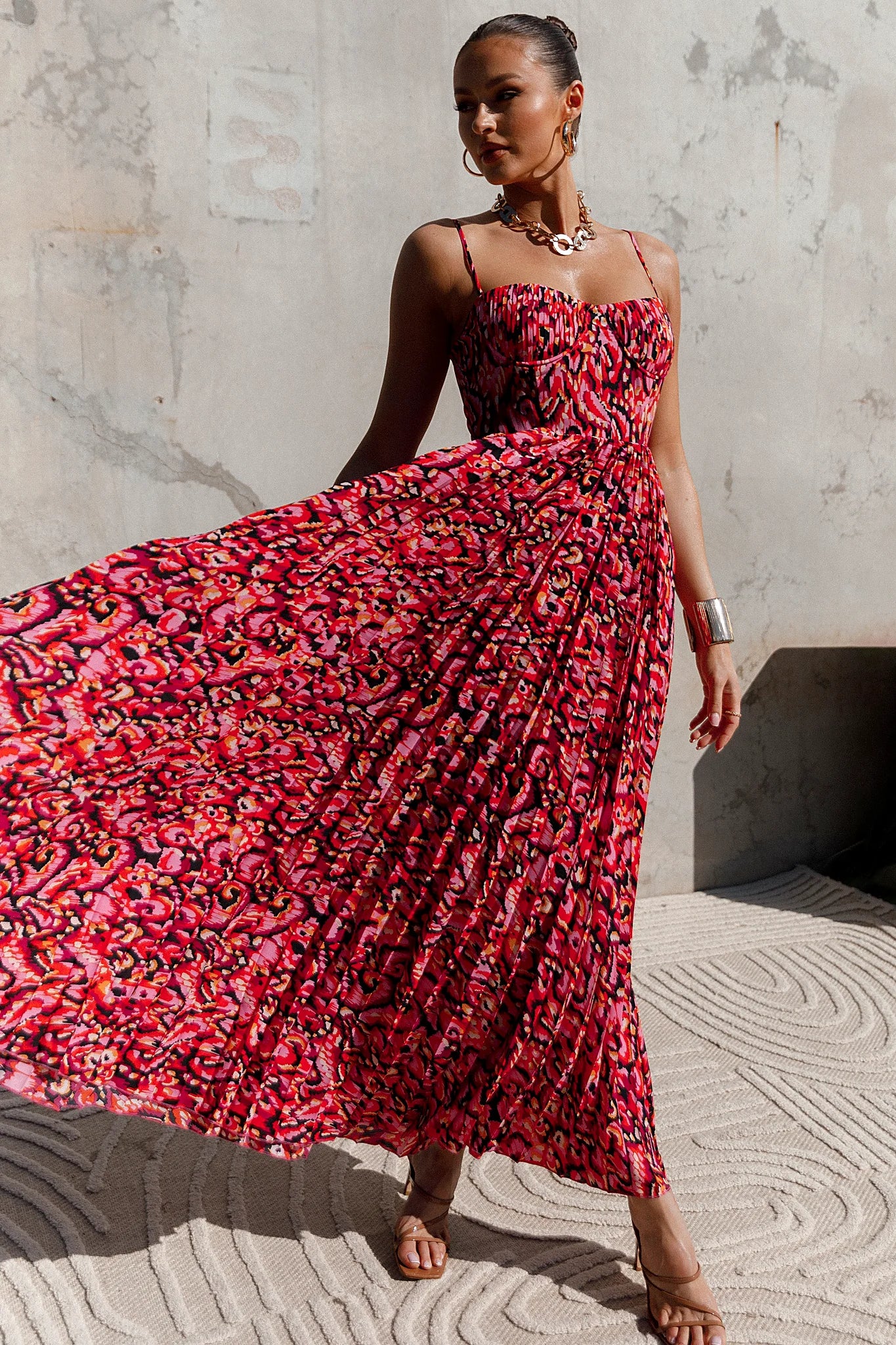 Back view of a pink pink multi pleated maxi dress, showing the fabric and hem finish