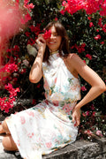 Front view of a white white floral high neck midi dress, showing the fit and drape of the skirt
