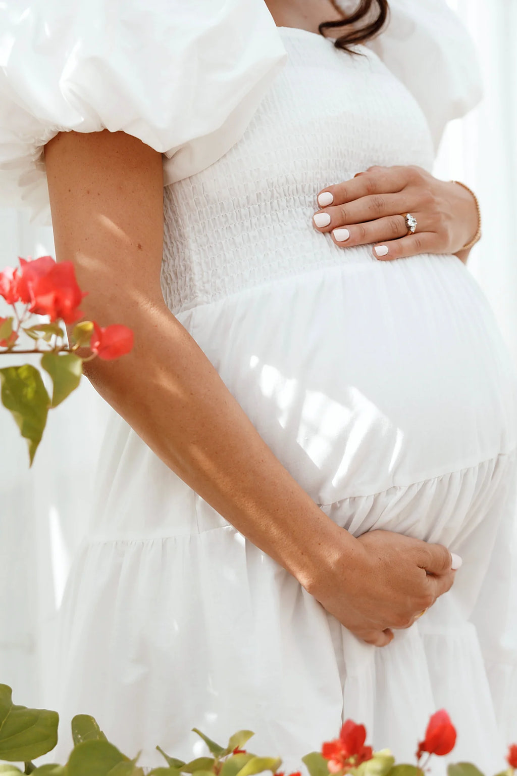 Side view of a white white smocked puff sleeve midi dress, showing the fit and drape of the skirt