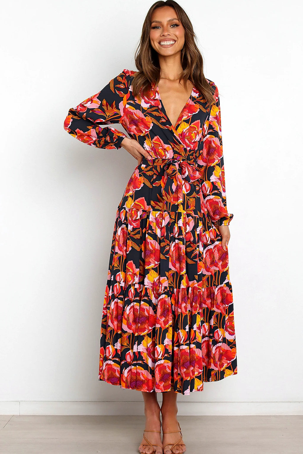 Side view of a navy navy floral tiered overlay maxi dress, showing the fabric and hem finish