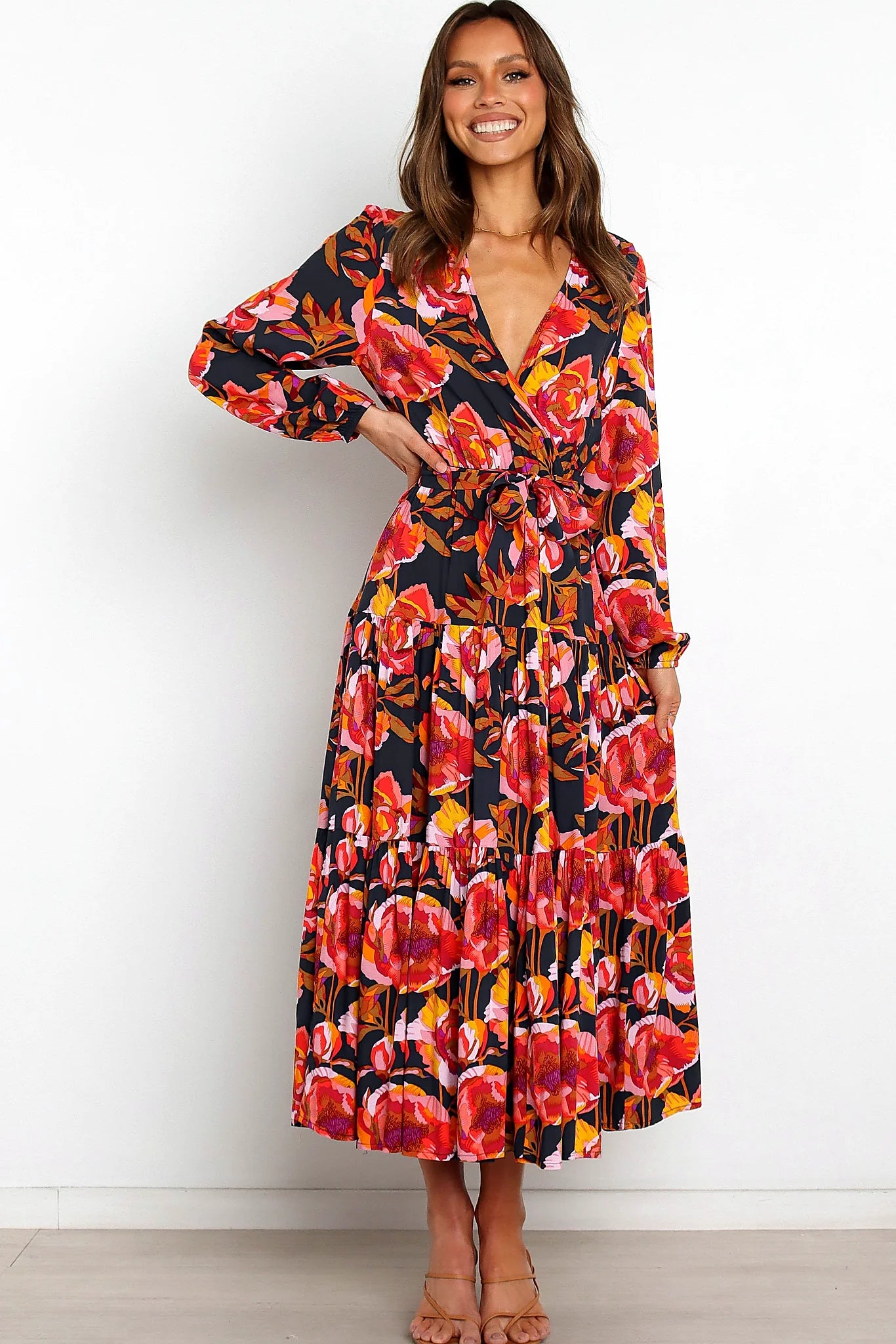 Side view of a navy navy floral tiered overlay maxi dress, showing the fabric and hem finish
