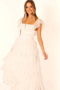 Front view of a white off white tulle maxi dress, worn by a model against a plain studio backdrop