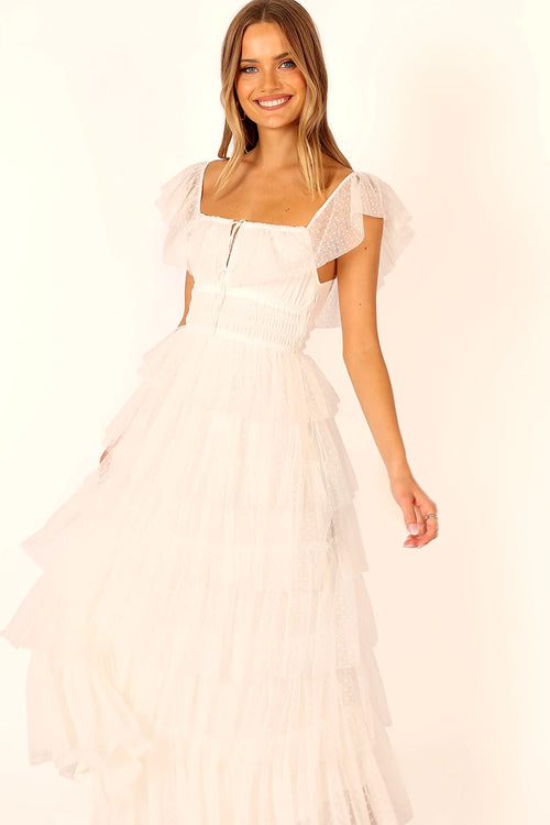 Front view of a white off white tulle maxi dress, worn by a model against a plain studio backdrop