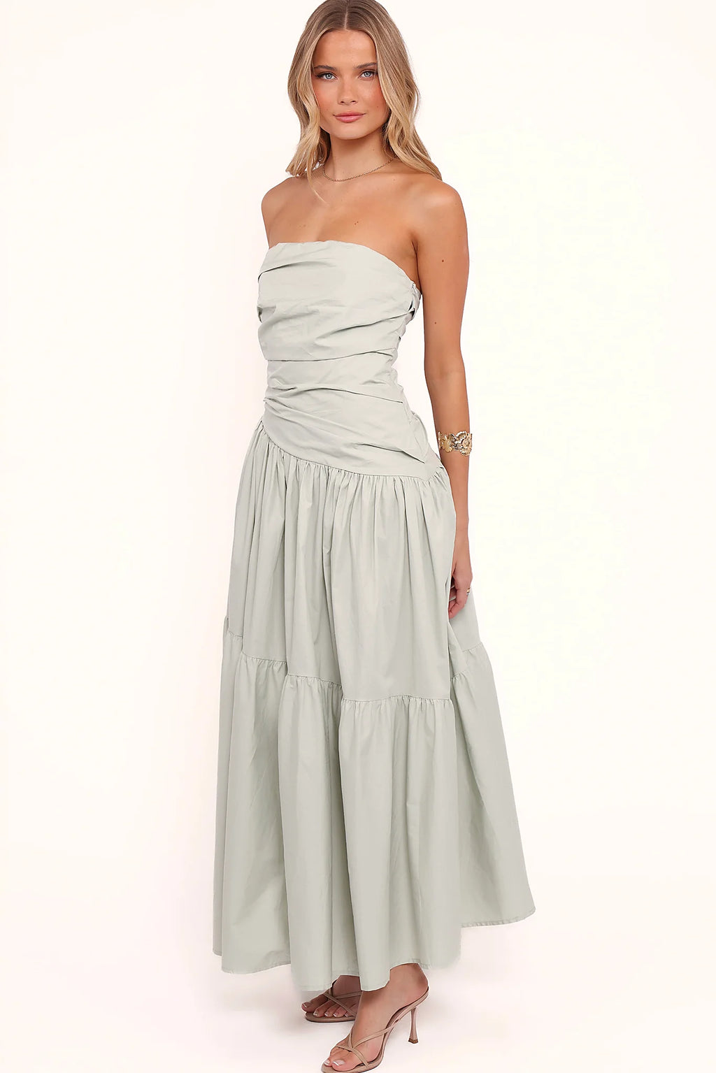 Side view of a mint strapless maxi dress, tiered skirt, showing the fabric and hem finish