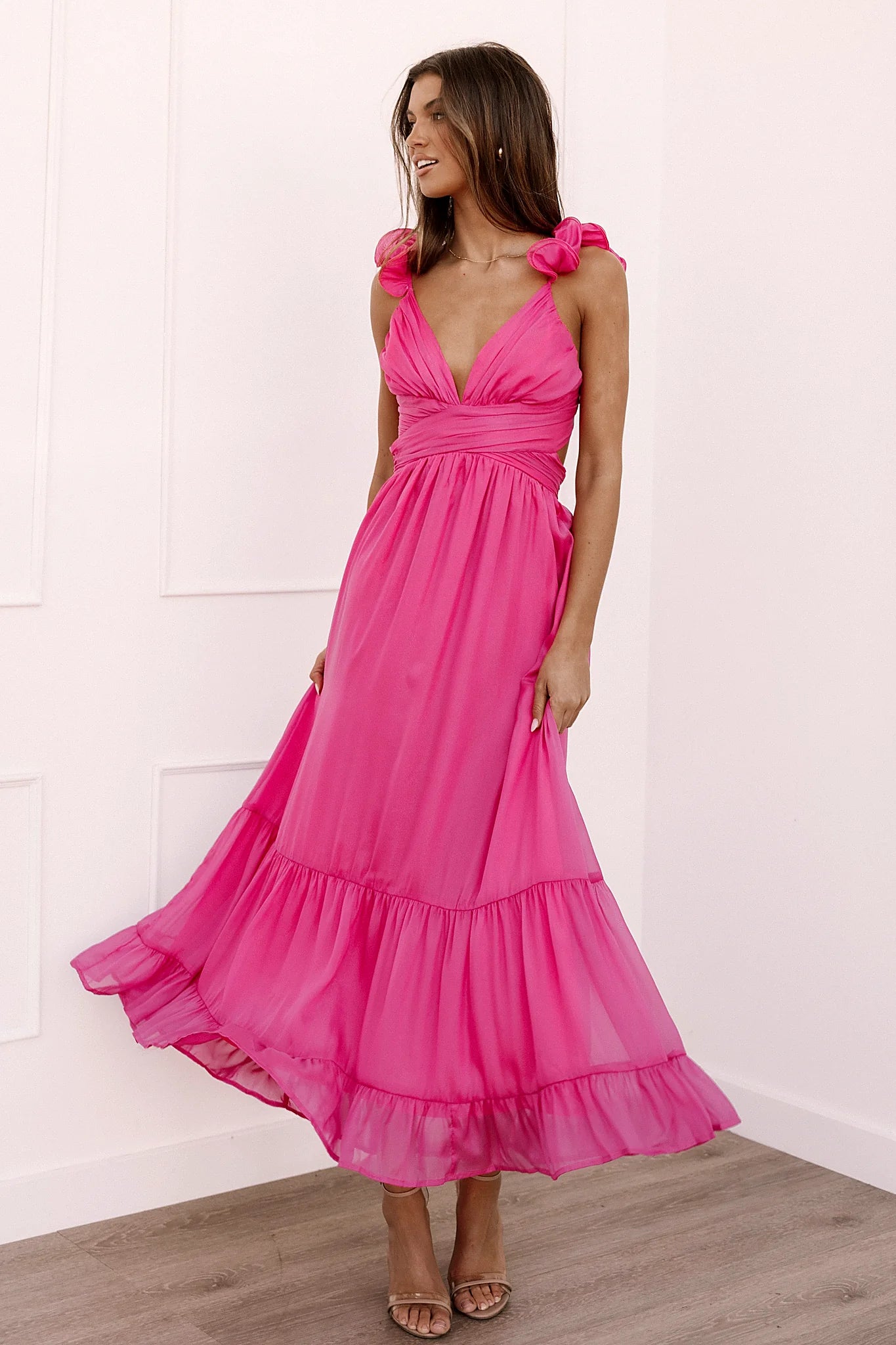 Back view of a up back berry midi dress, lace, worn by a model against a plain studio backdrop