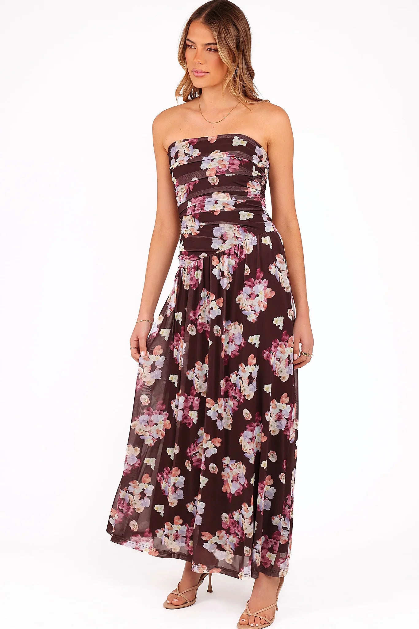 Close-up detail of a brown purple floral strapless maxi dress, showing the neckline and bodice detail
