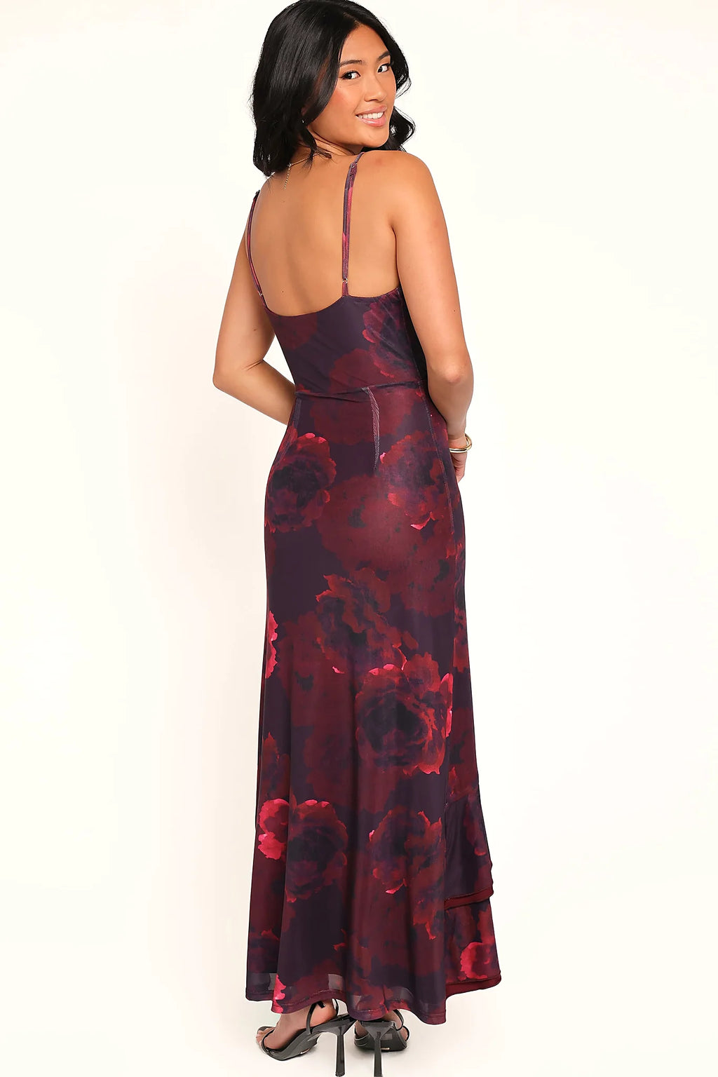 Red floral gown worn at a garden wedding near sunset