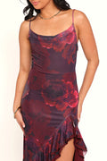Front view of a red red floral maxi dress, ruffle split, worn by a model against a plain studio backdrop