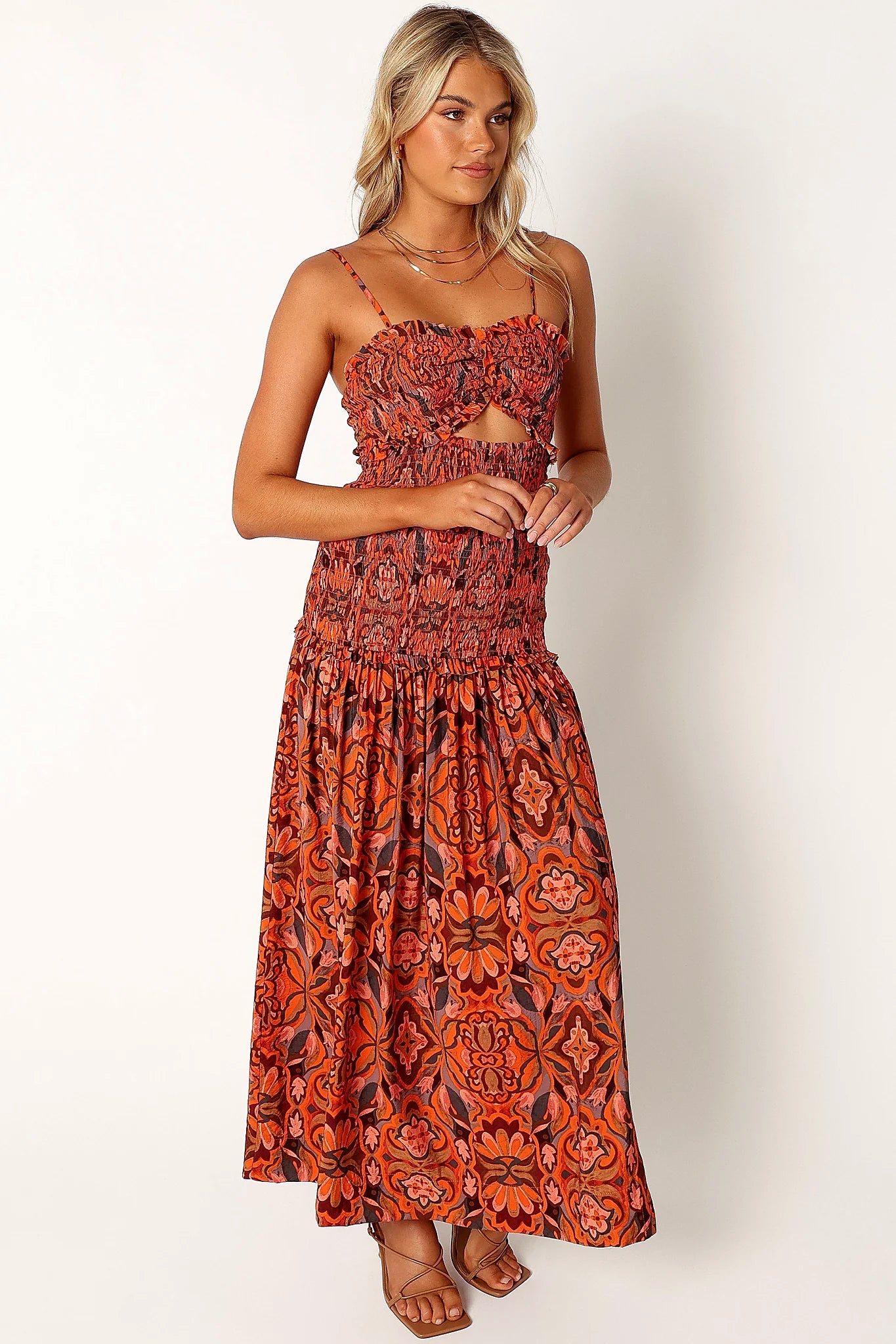 Back view of a harvest moon floral midi dress, worn by a model against a plain studio backdrop