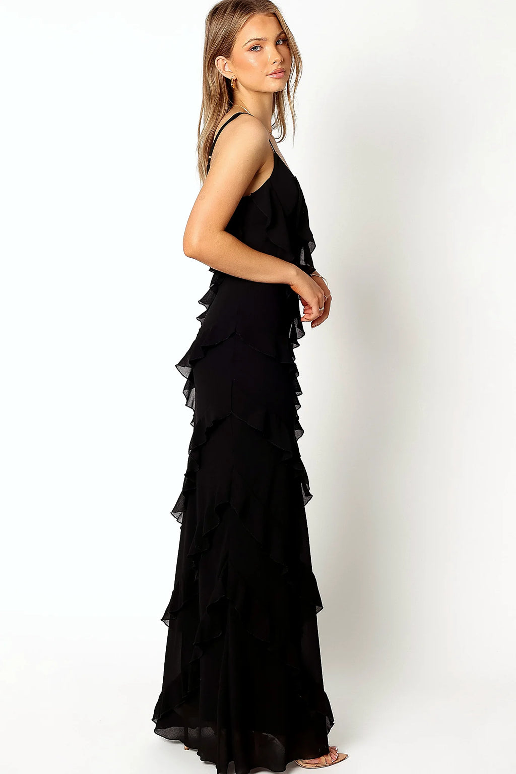 Close-up detail of a black black ruffle maxi dress, v back, showing the fabric and hem finish