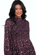 Front view of a plum floral shirred midi dress, frill sleeves, showing the fabric and hem finish