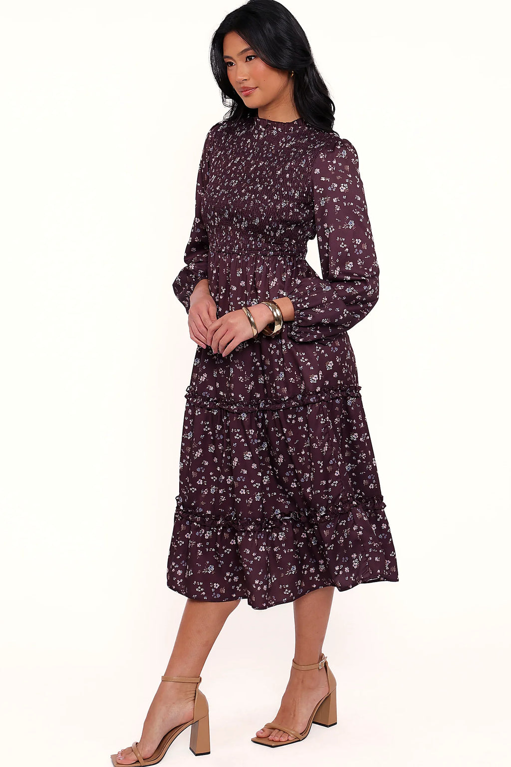 Side view of a plum floral shirred midi dress, frill sleeves, showing the fit and drape of the skirt