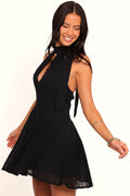 Black mini dress with a deep V neckline and halterneck tie