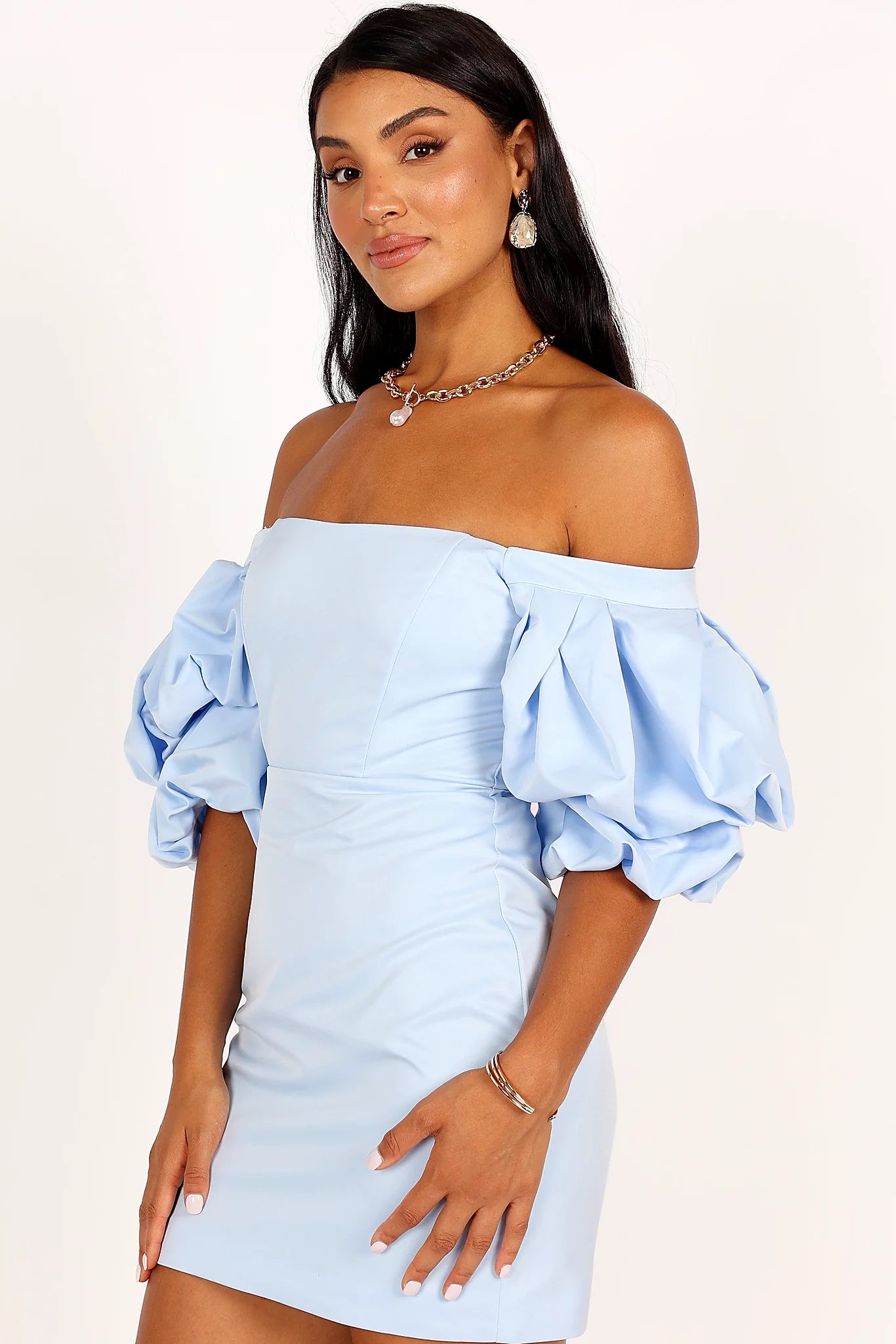 Side view of a icy blue puff sleeve mini dress, showing the neckline and bodice detail