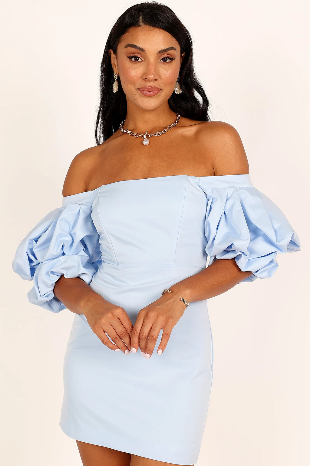 Back view of a icy blue puff sleeve mini dress, showing the fit and drape of the skirt