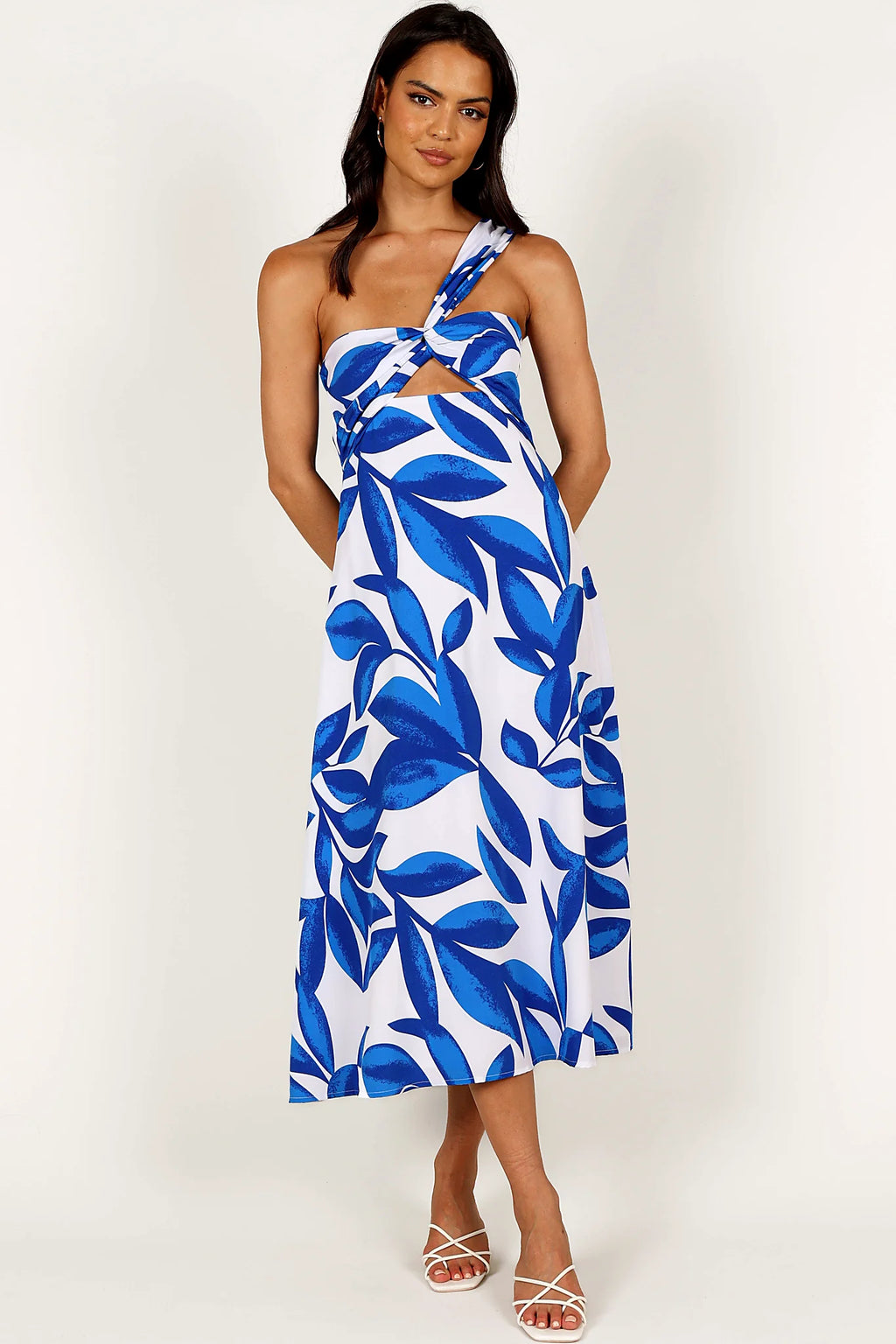 Close-up detail of a white/blue midi dress, showing the fit and drape of the skirt