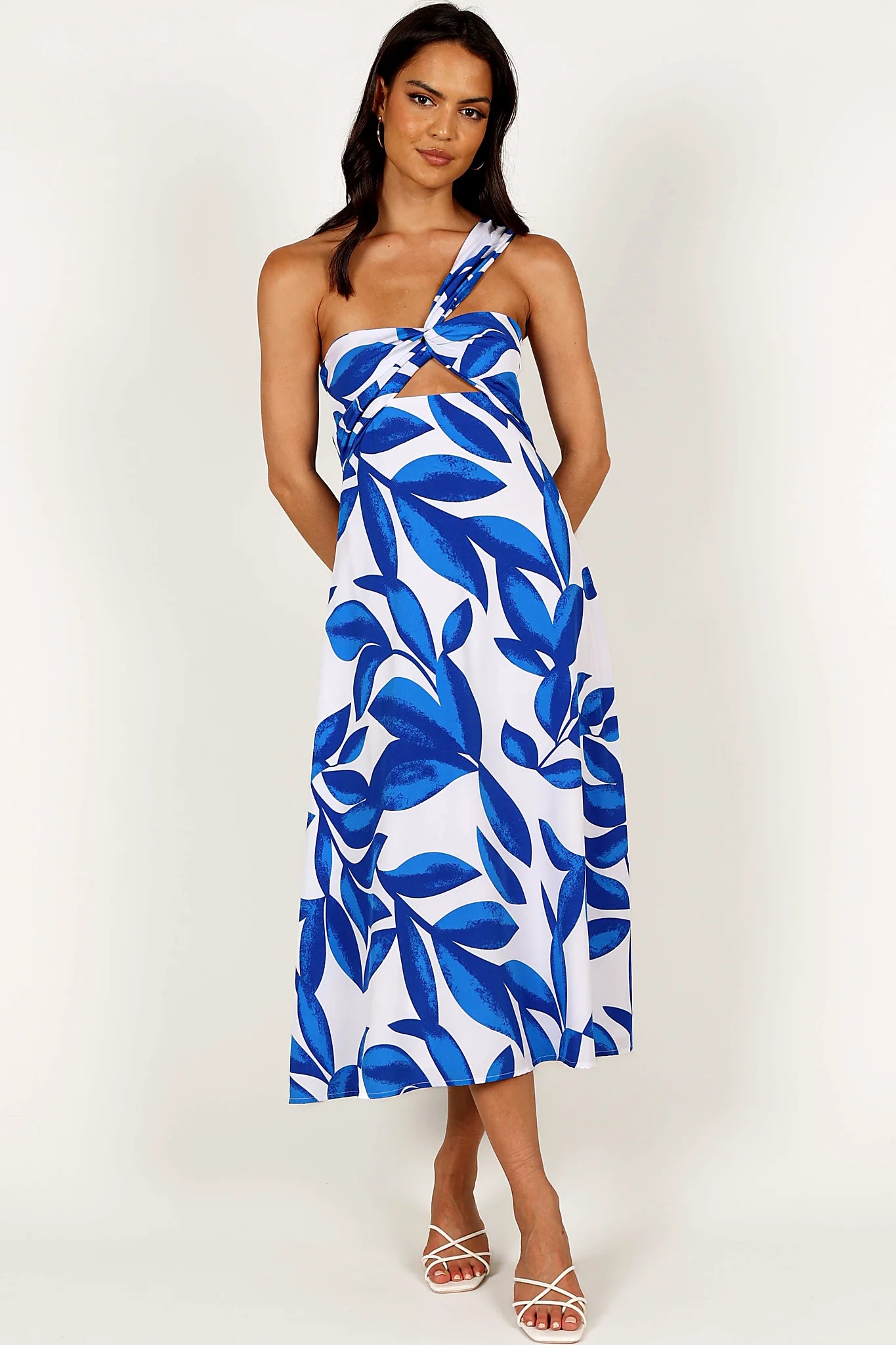 Close-up detail of a white/blue midi dress, showing the fit and drape of the skirt