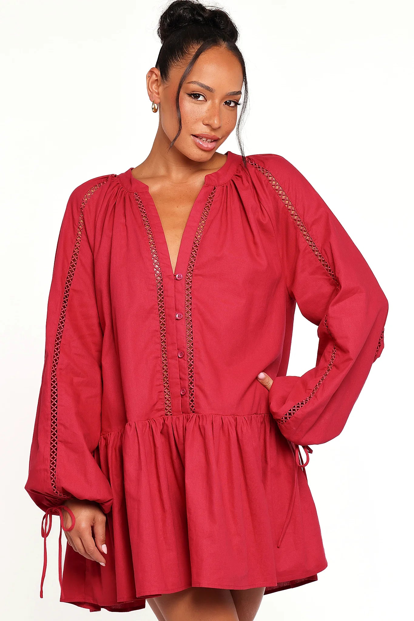 Back view of a red wine mini dress with long sleeves, showing the fabric and hem finish