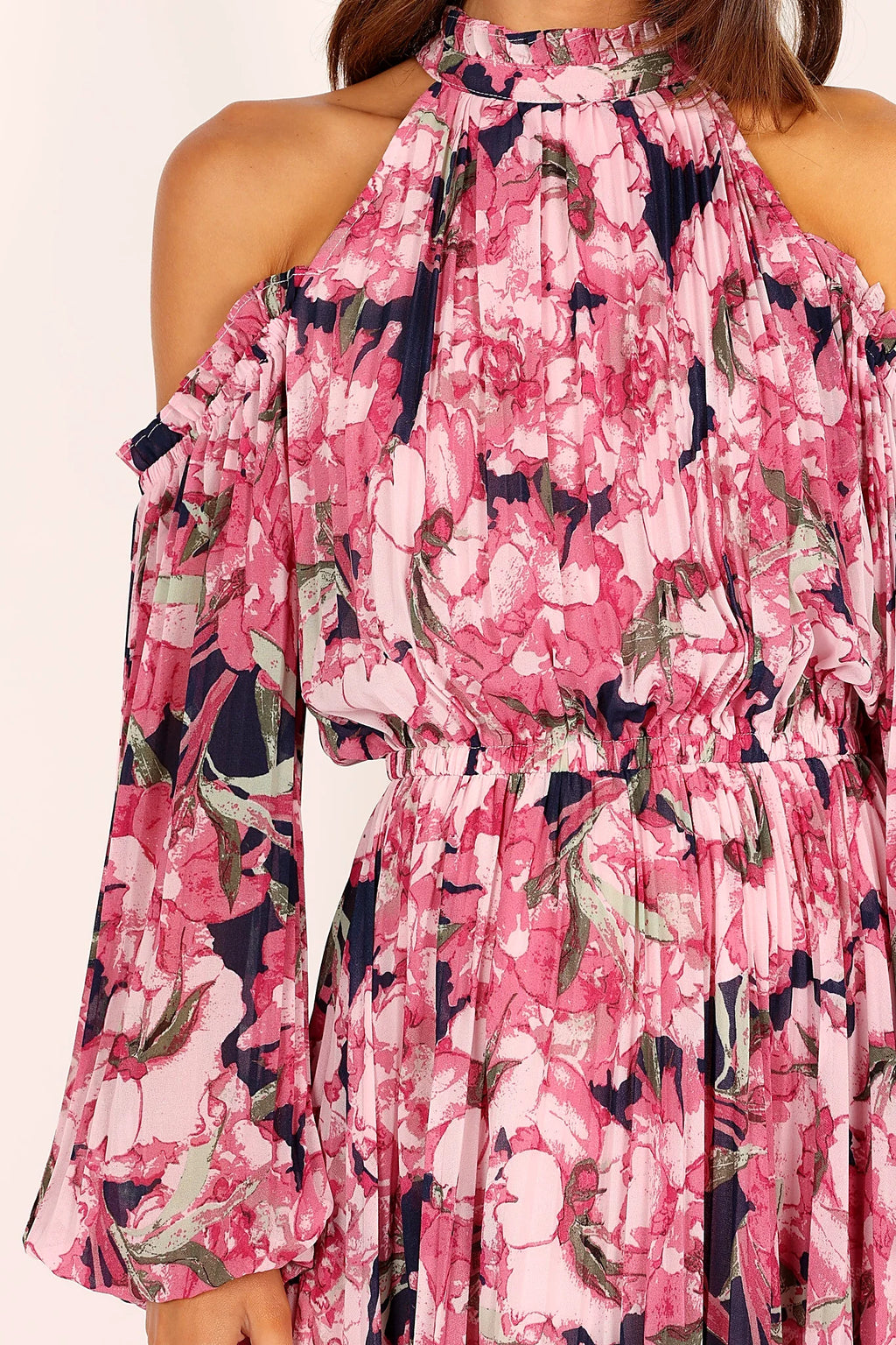 Side view of a pink pink floral pleated maxi dress, showing the fabric and hem finish