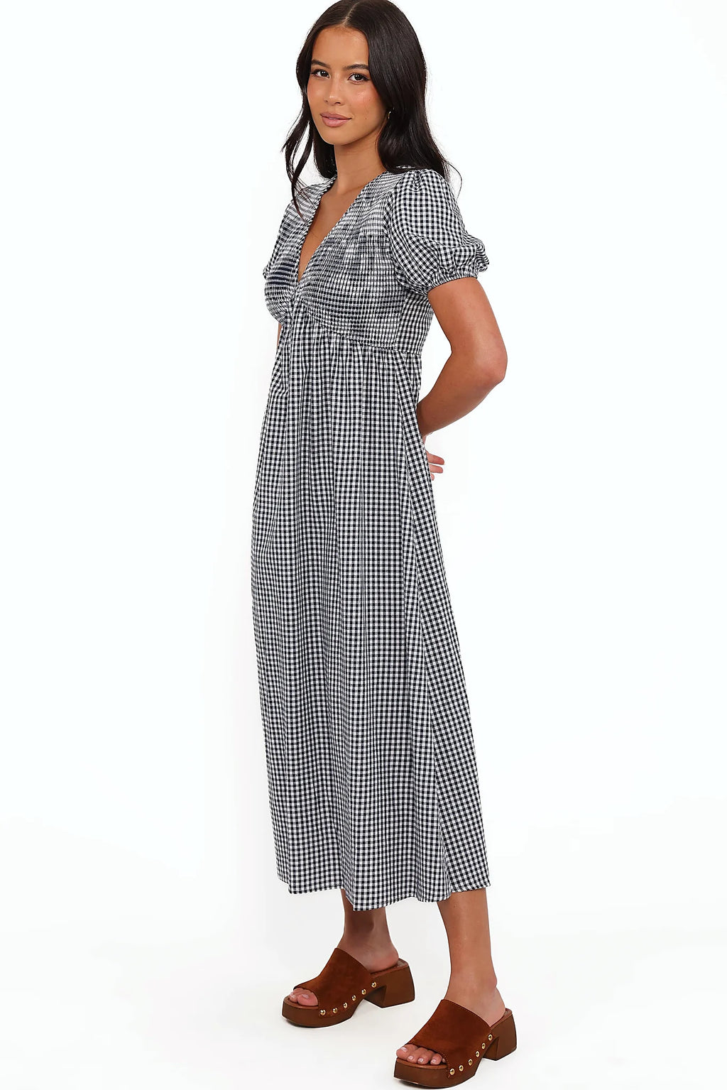 Close-up detail of a navy gingham short sleeve maxi dress, showing the fabric and hem finish