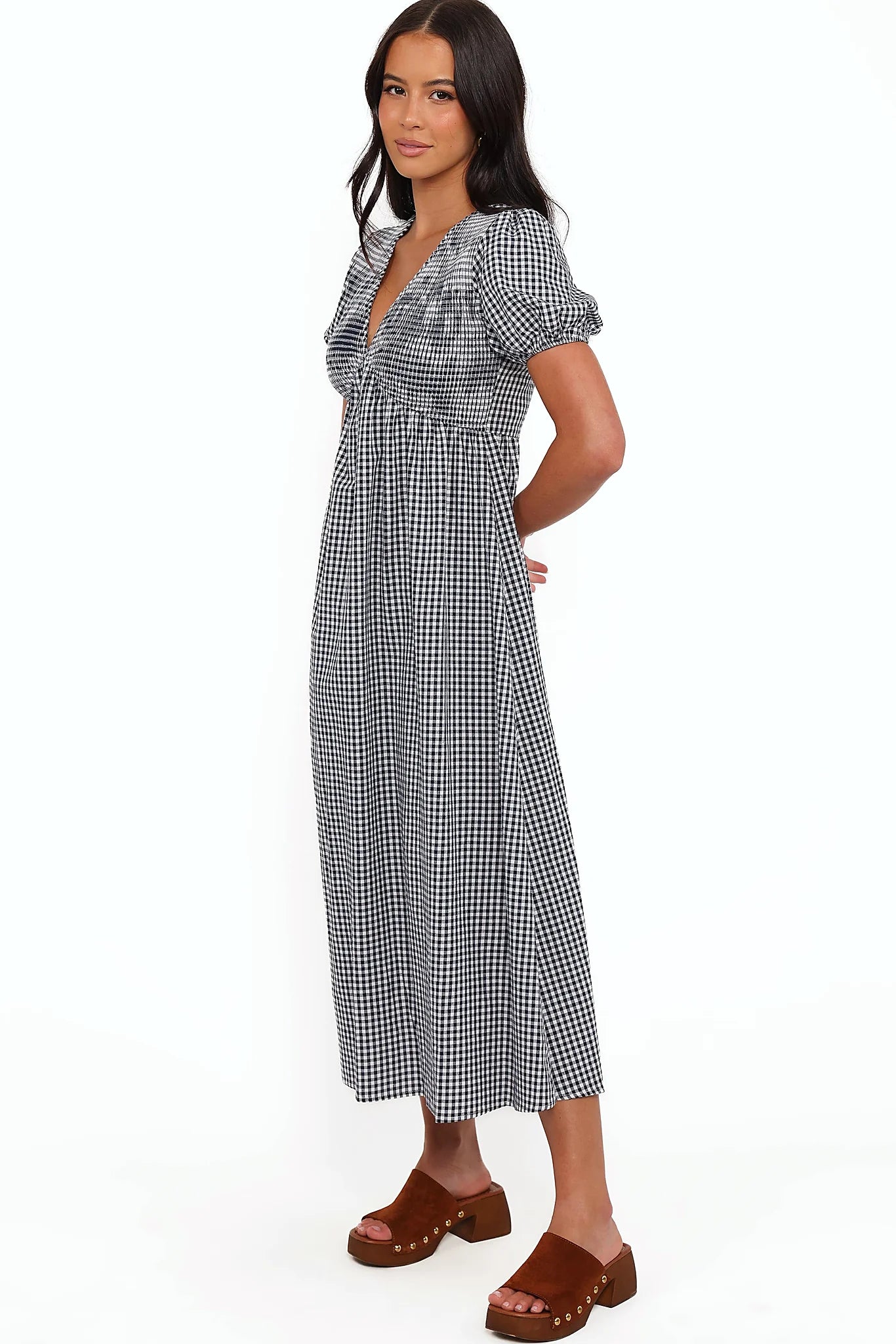 Close-up detail of a navy gingham short sleeve maxi dress, showing the fabric and hem finish