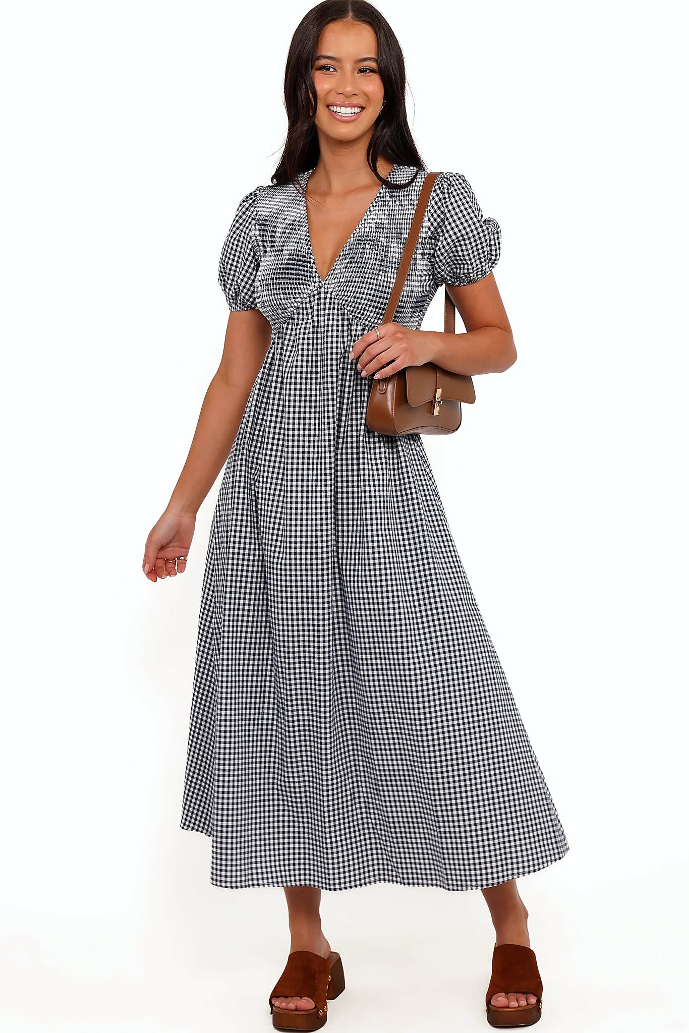 Front view of a navy gingham short sleeve maxi dress, worn by a model against a plain studio backdrop