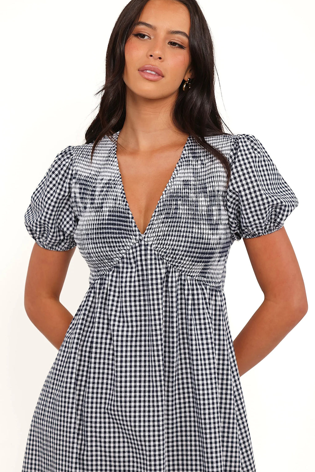 Side view of a navy gingham short sleeve maxi dress, showing the neckline and bodice detail