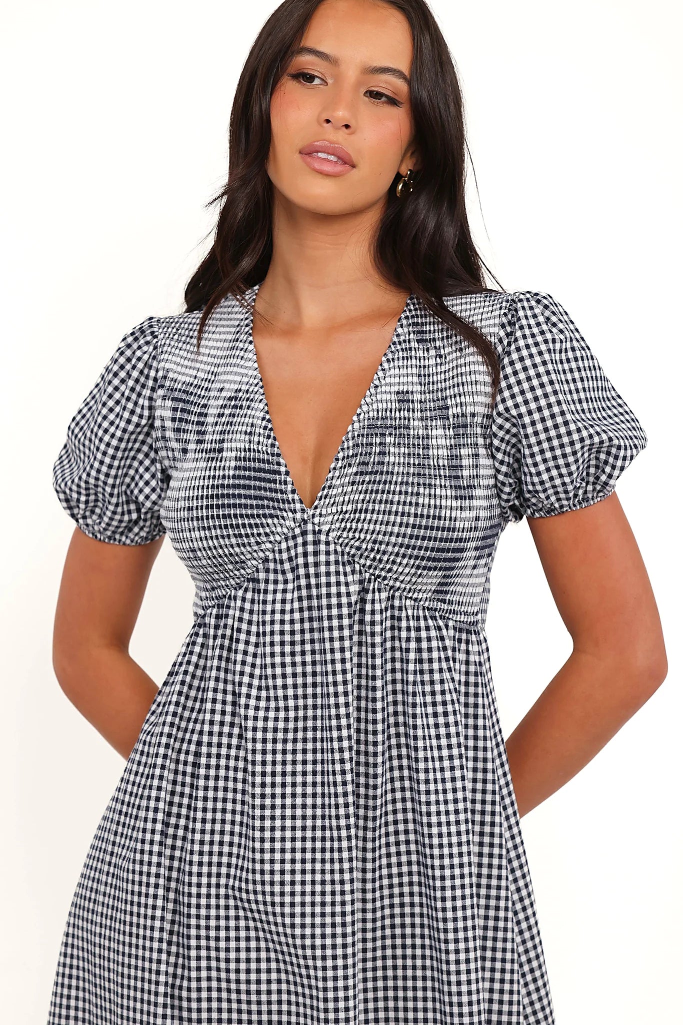 Side view of a navy gingham short sleeve maxi dress, showing the neckline and bodice detail