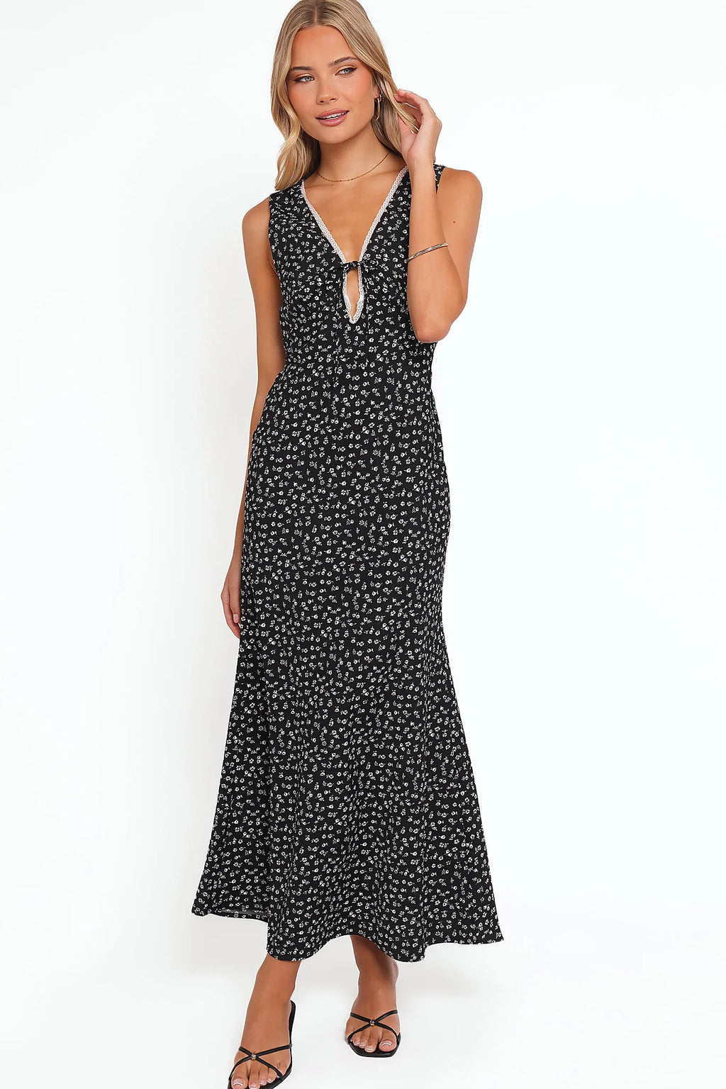 Back view of a black black floral maxi dress with lace trim, showing the fit and drape of the skirt