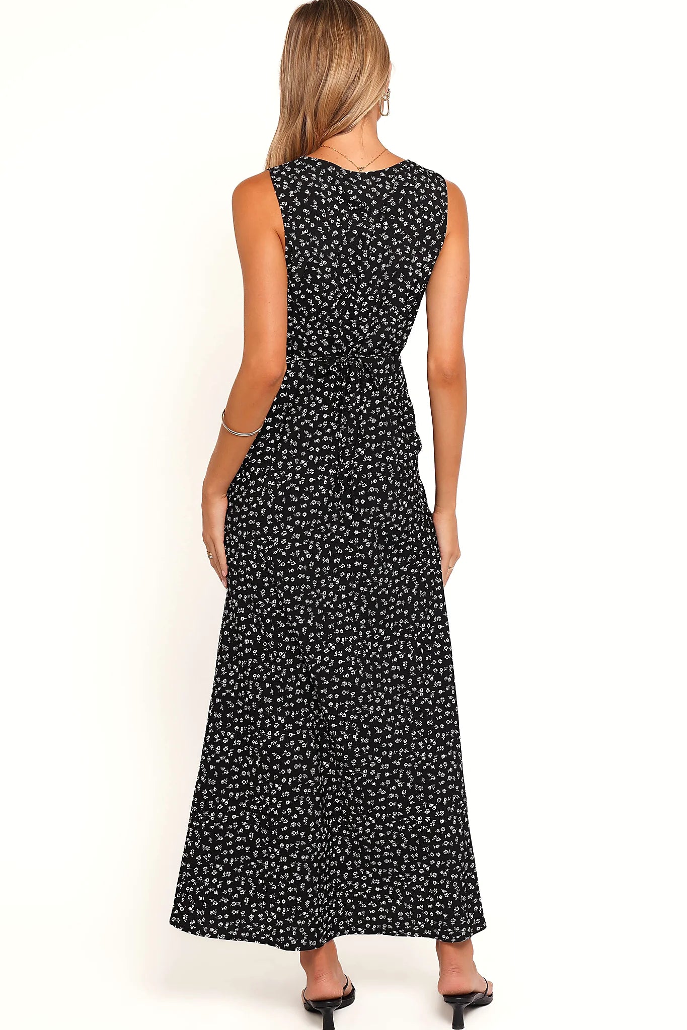 Close-up detail of a black black floral maxi dress with lace trim, showing the fabric and hem finish