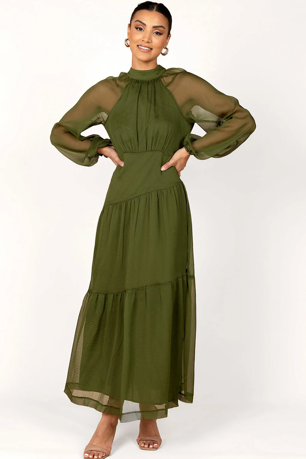 Back view of a olive maxi dress with sheer sleeves, worn by a model against a plain studio backdrop
