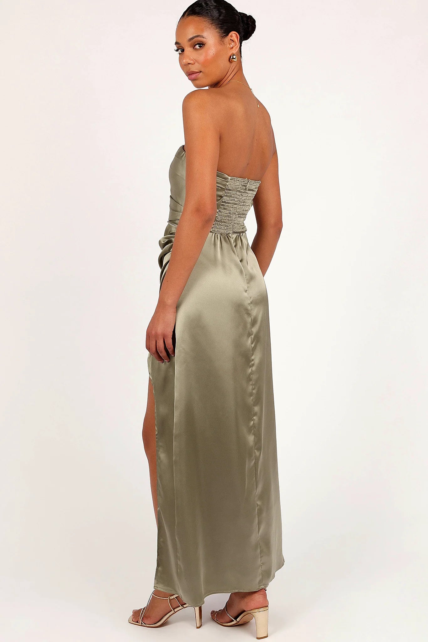 Close-up detail of a black olive strapless maxi dress with split, showing the fit and drape of the skirt