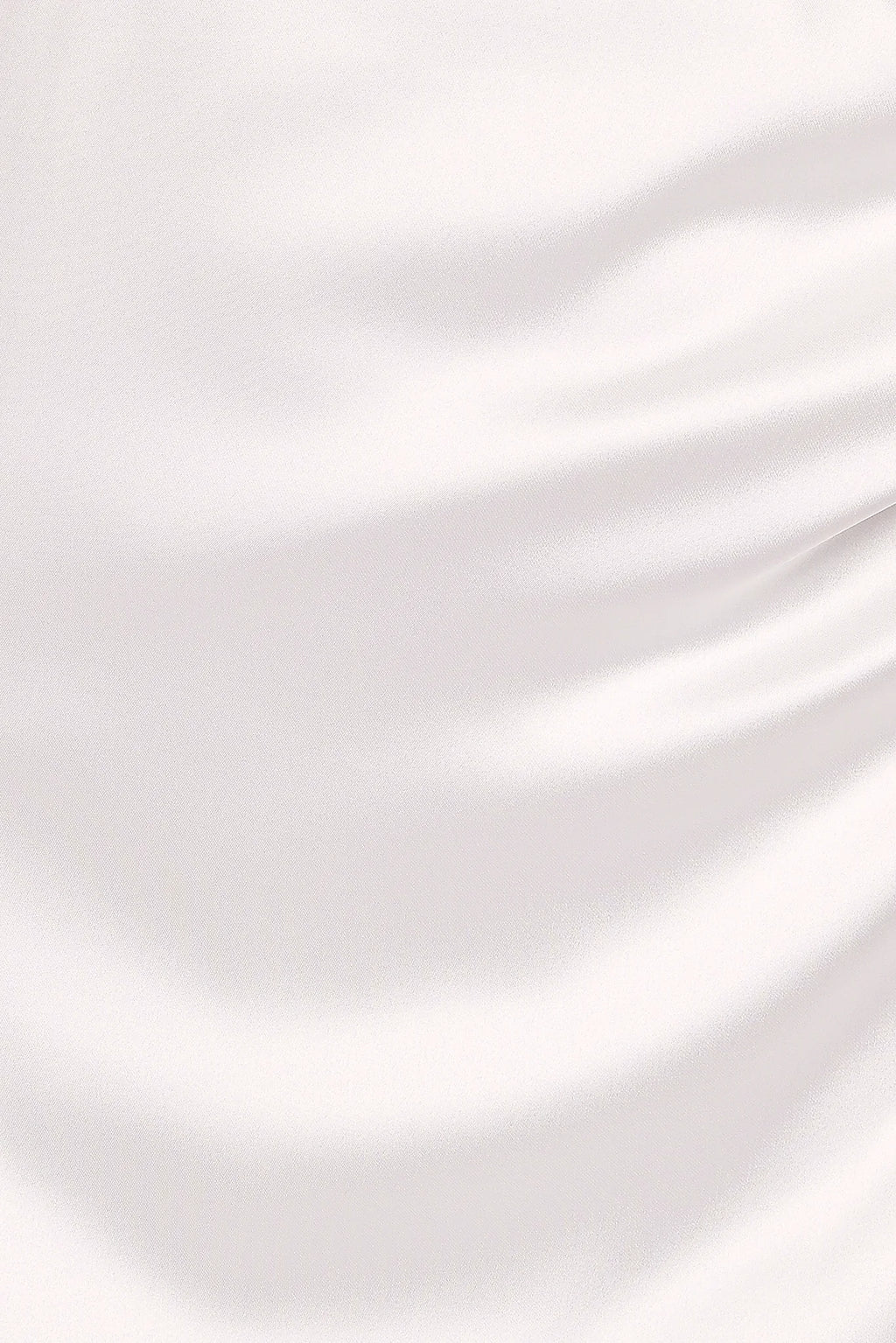 Close-up detail of a white strapless maxi dress, worn by a model against a plain studio backdrop