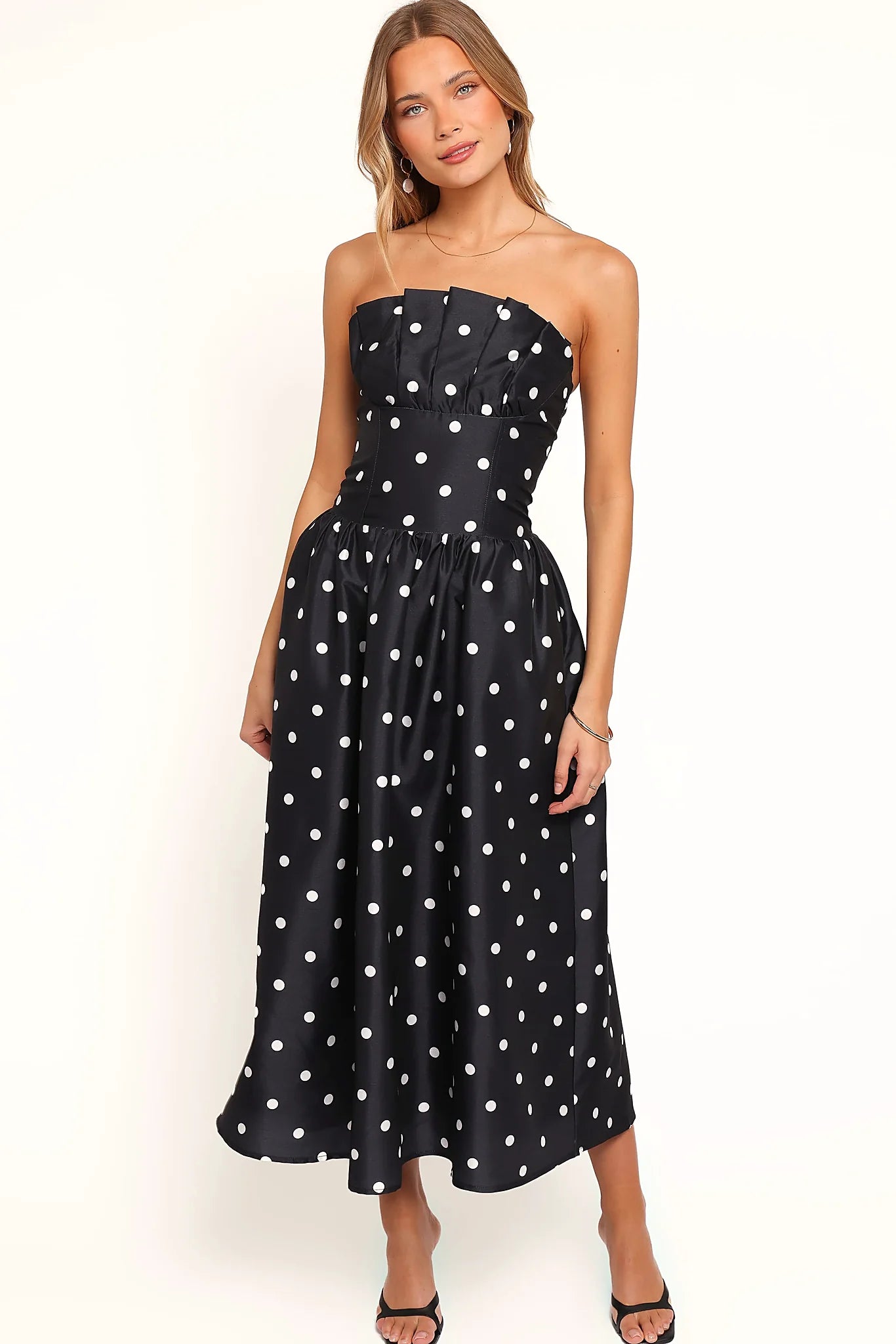 Front view of a line polka dot strapless midi dress, a, showing the fabric and hem finish