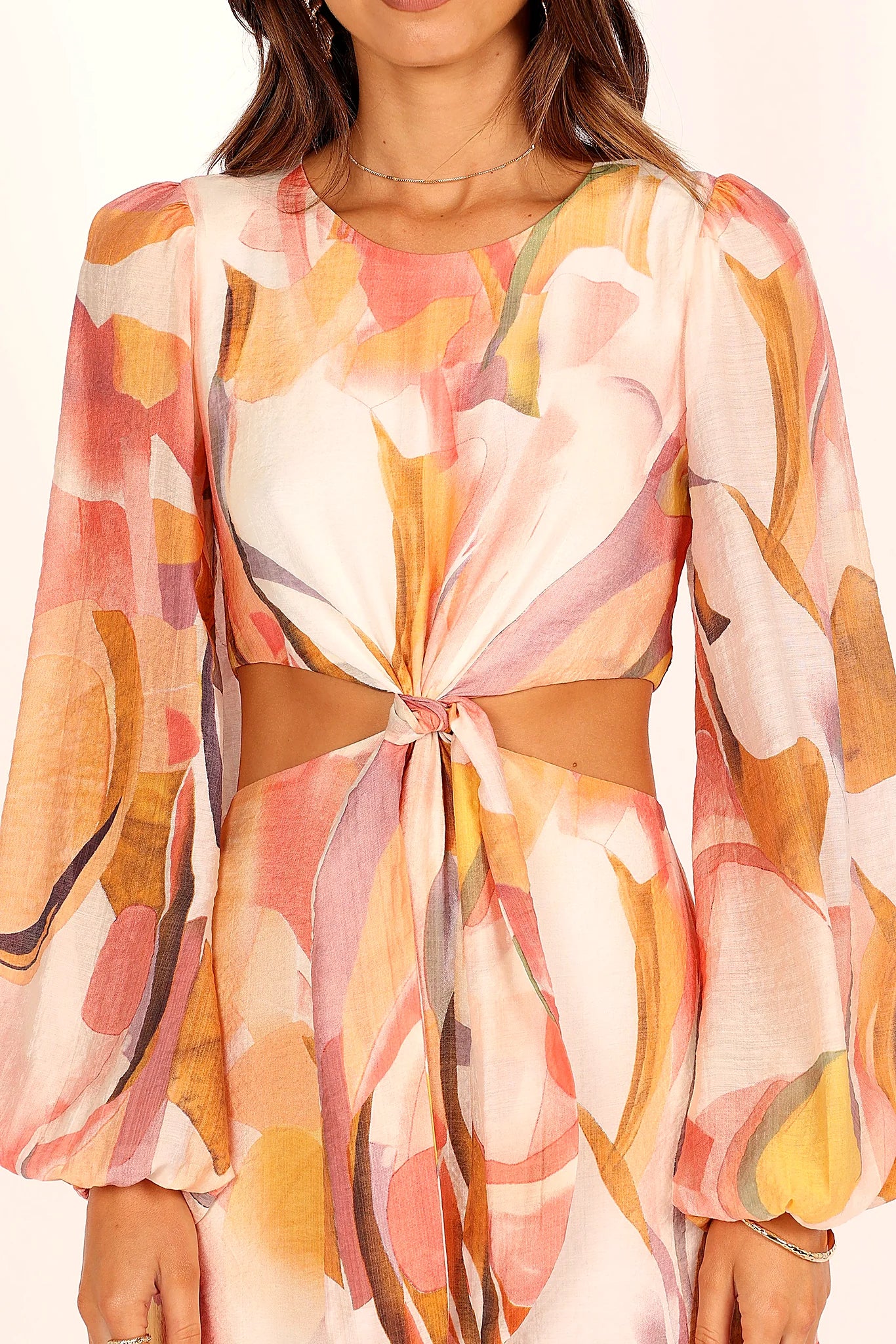 Side view of a pink pink abstract print maxi dress, showing the fit and drape of the skirt