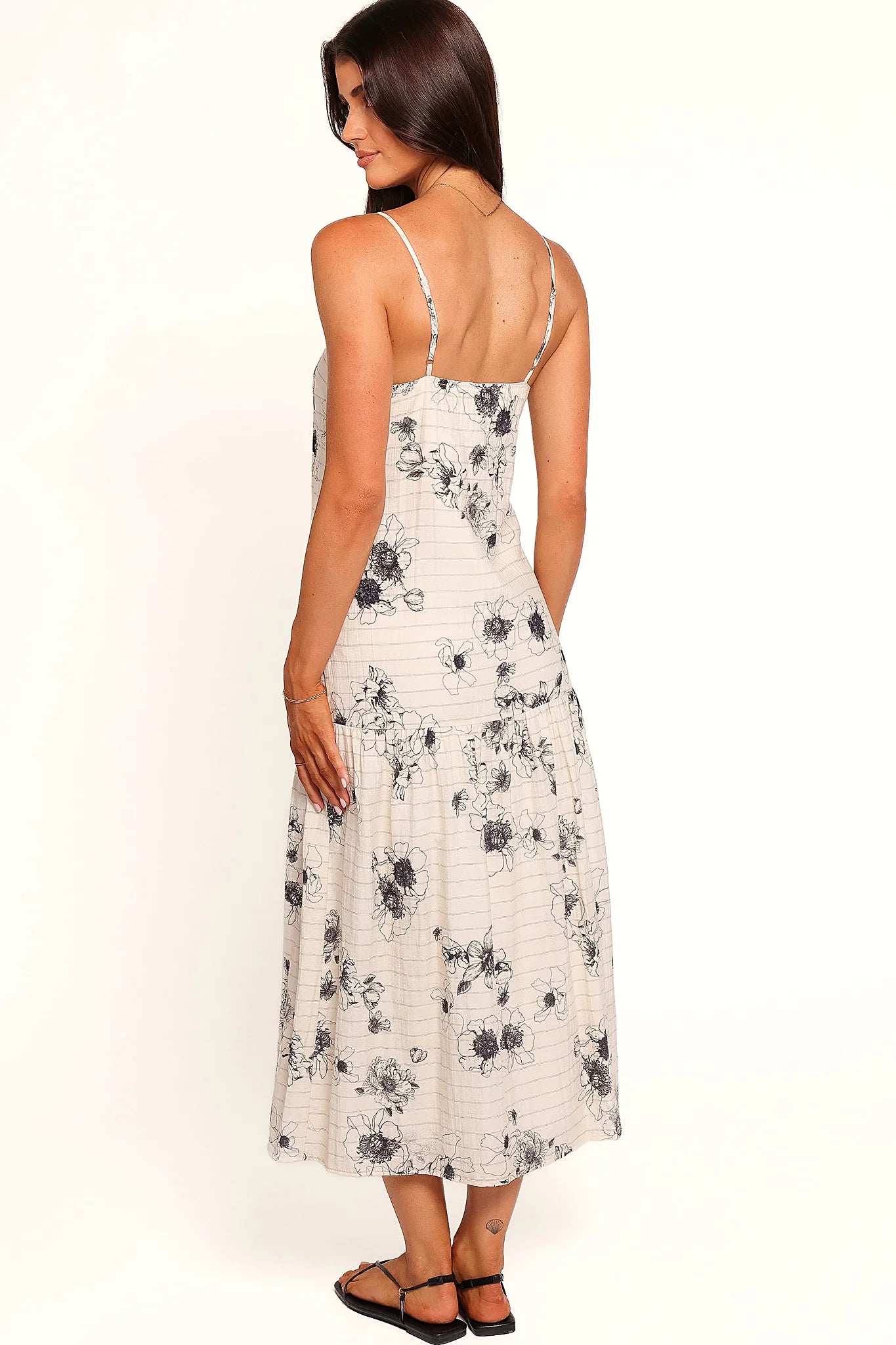 Close-up detail of a black black & ivory floral maxi dress, showing the fit and drape of the skirt