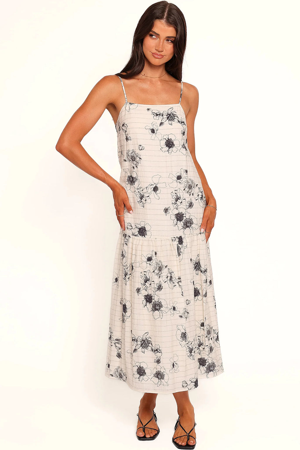 Back view of a black black & ivory floral maxi dress, showing the fabric and hem finish