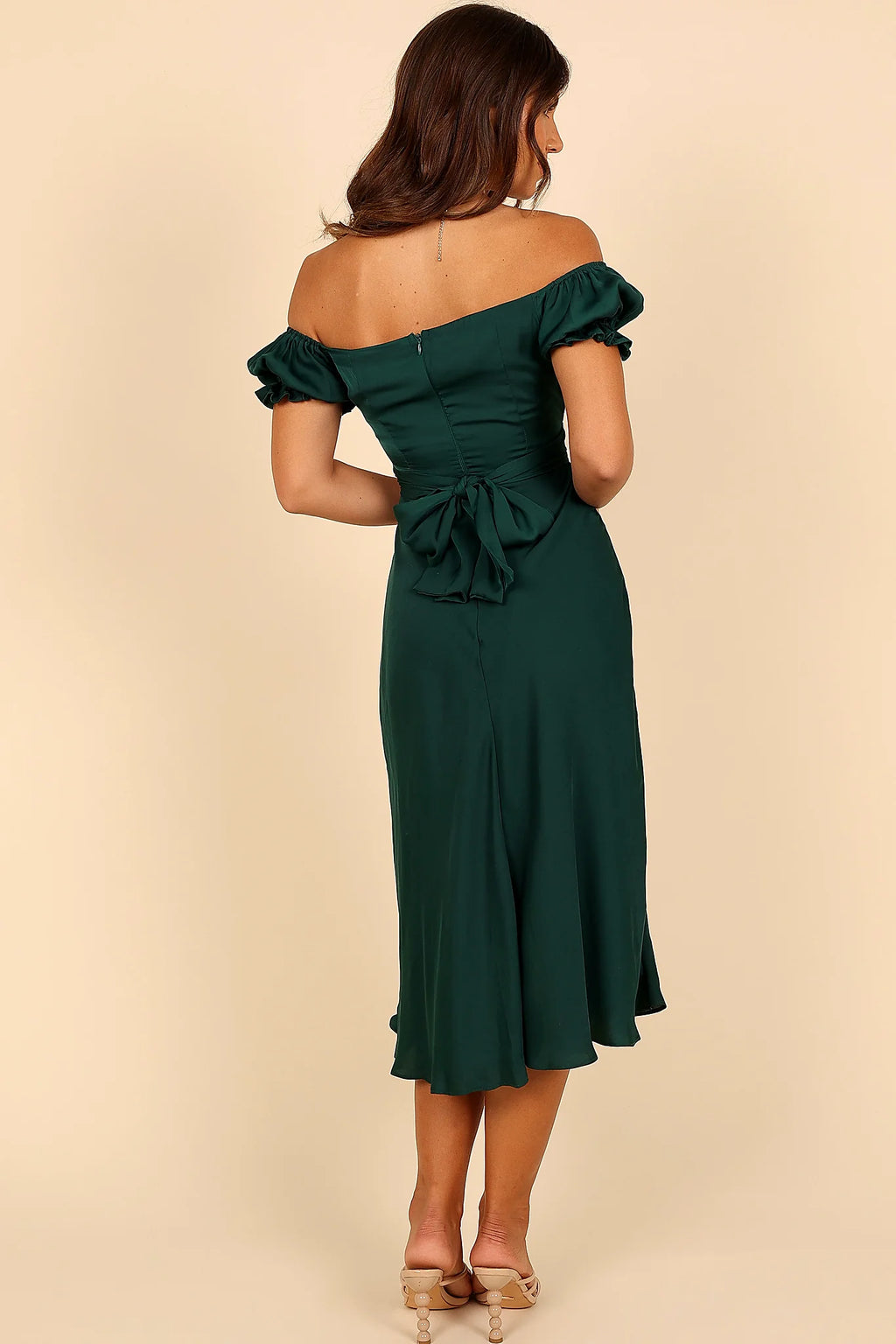 Side view of a green emerald off shoulder frill midi dress, showing the fabric and hem finish