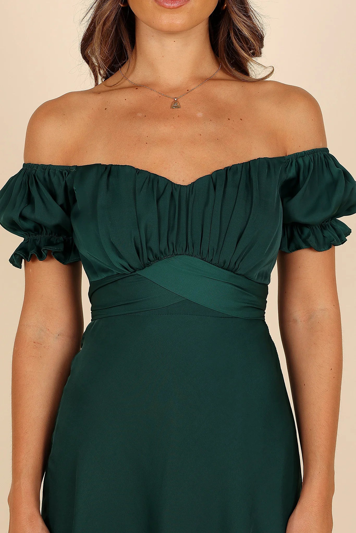 Front view of a green emerald off shoulder frill midi dress, showing the fit and drape of the skirt