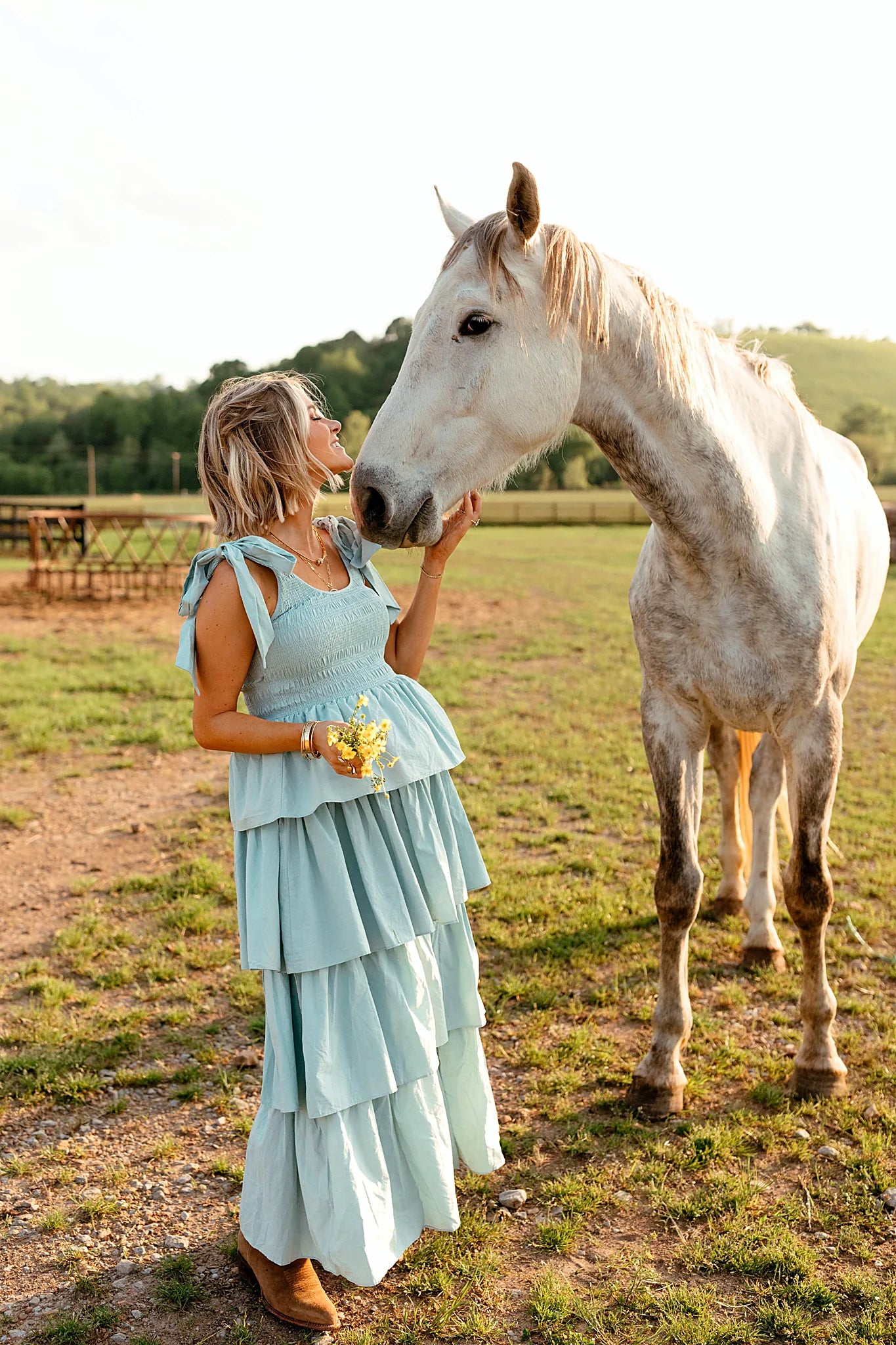 Back view of a blue blue tiered maxi dress, tie straps, showing the fabric and hem finish
