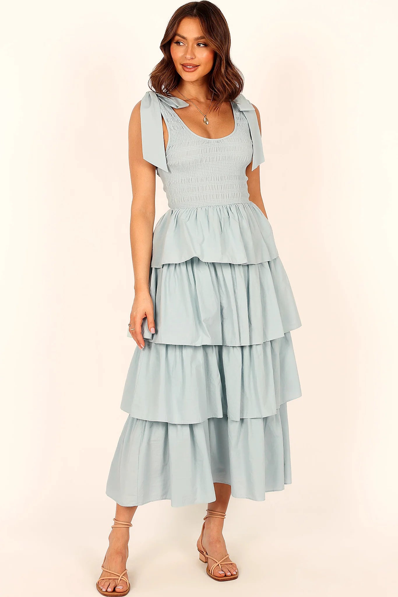 Close-up detail of a blue blue tiered maxi dress, tie straps, showing the fit and drape of the skirt