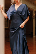 Front view of a navy satin maxi dress in midnight indigo, showing the fabric and hem finish