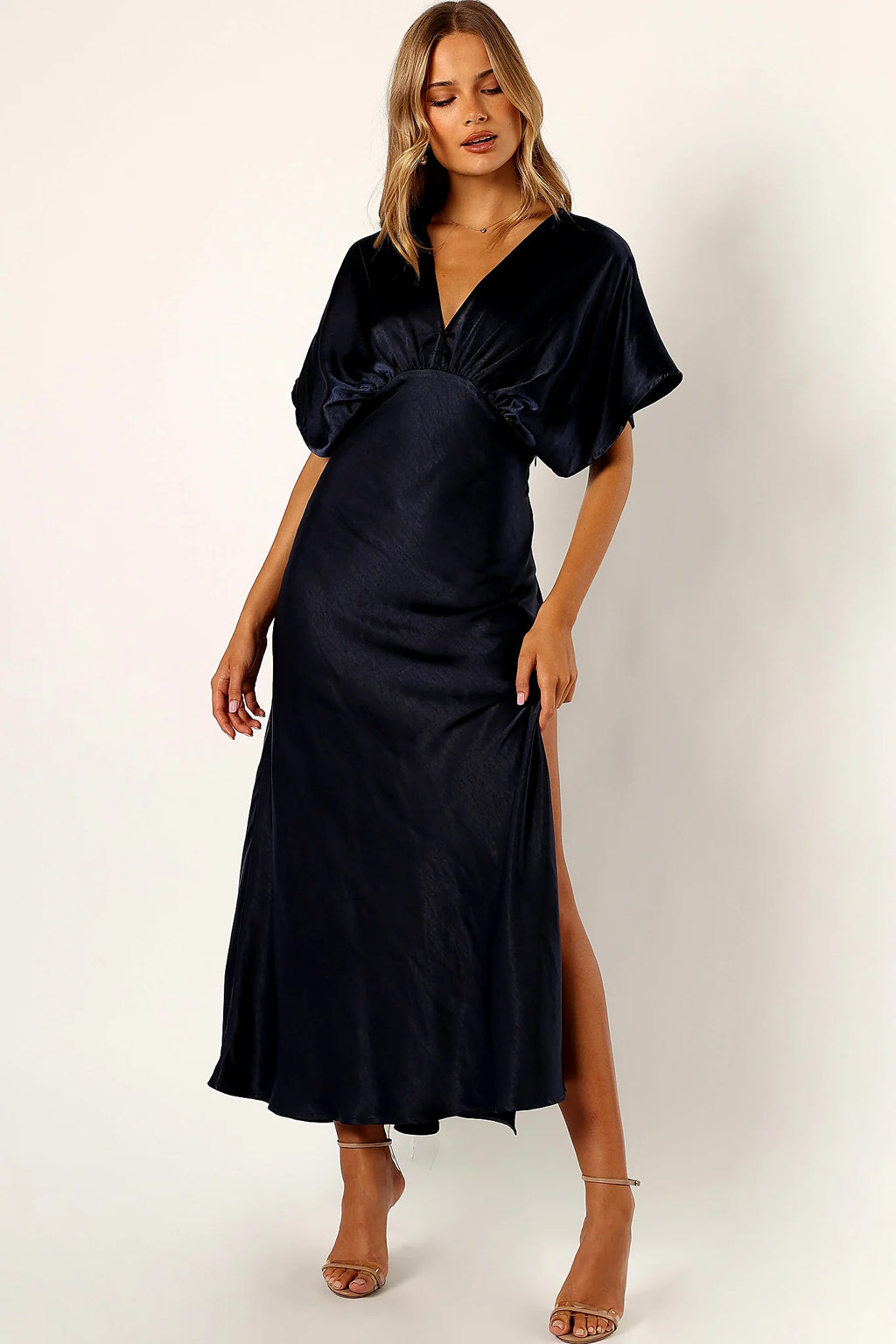 Close-up detail of a navy satin maxi dress in midnight indigo, showing the neckline and bodice detail