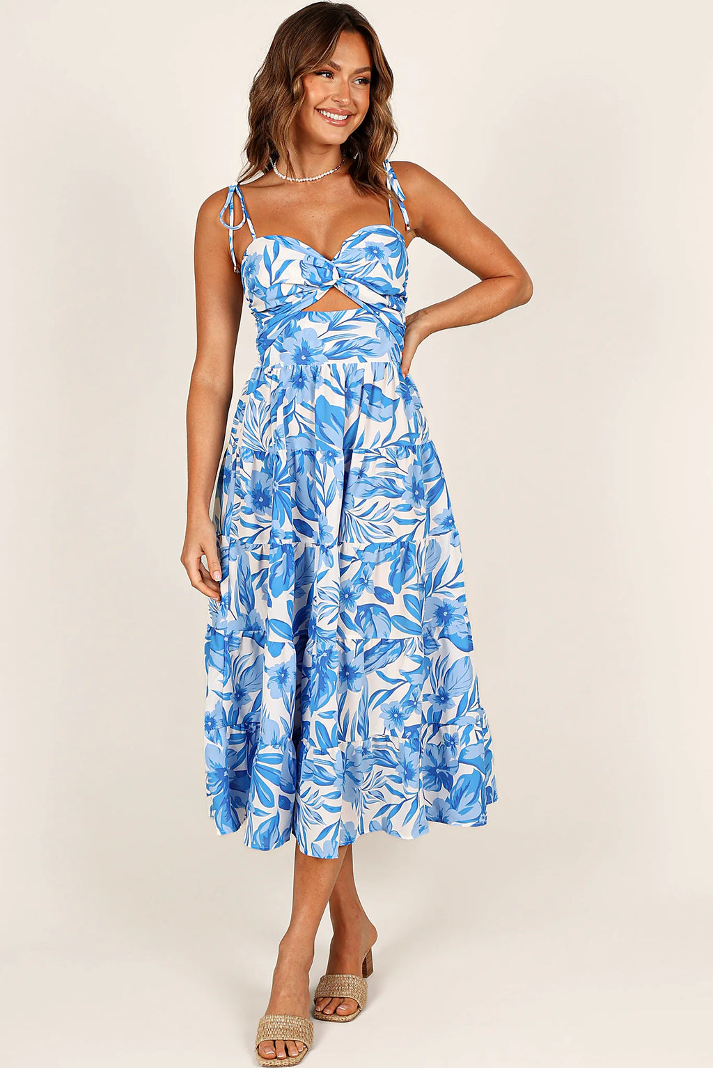 Back view of a blue/white midi dress, showing the fit and drape of the skirt