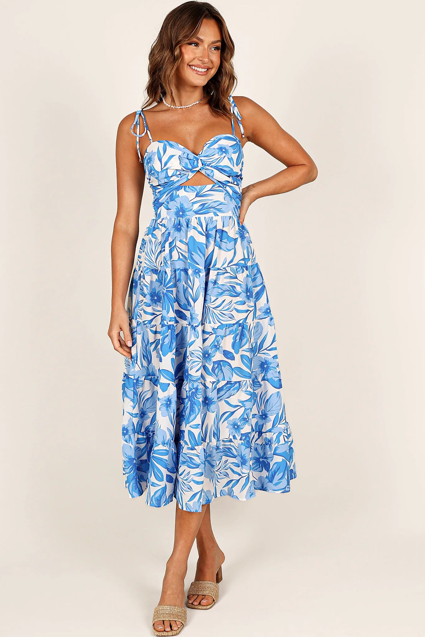 Back view of a blue/white midi dress, showing the fit and drape of the skirt