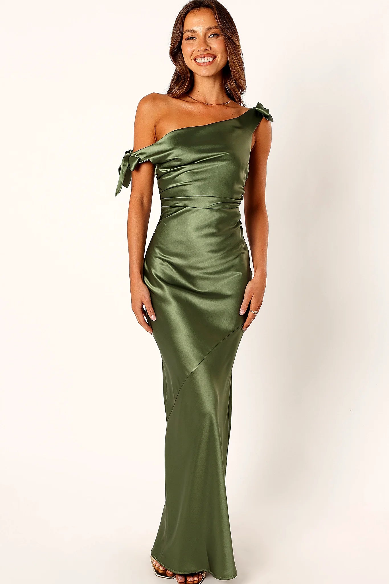 Front view of a olive asymmetric maxi dress, satin feel, showing the fit and drape of the skirt
