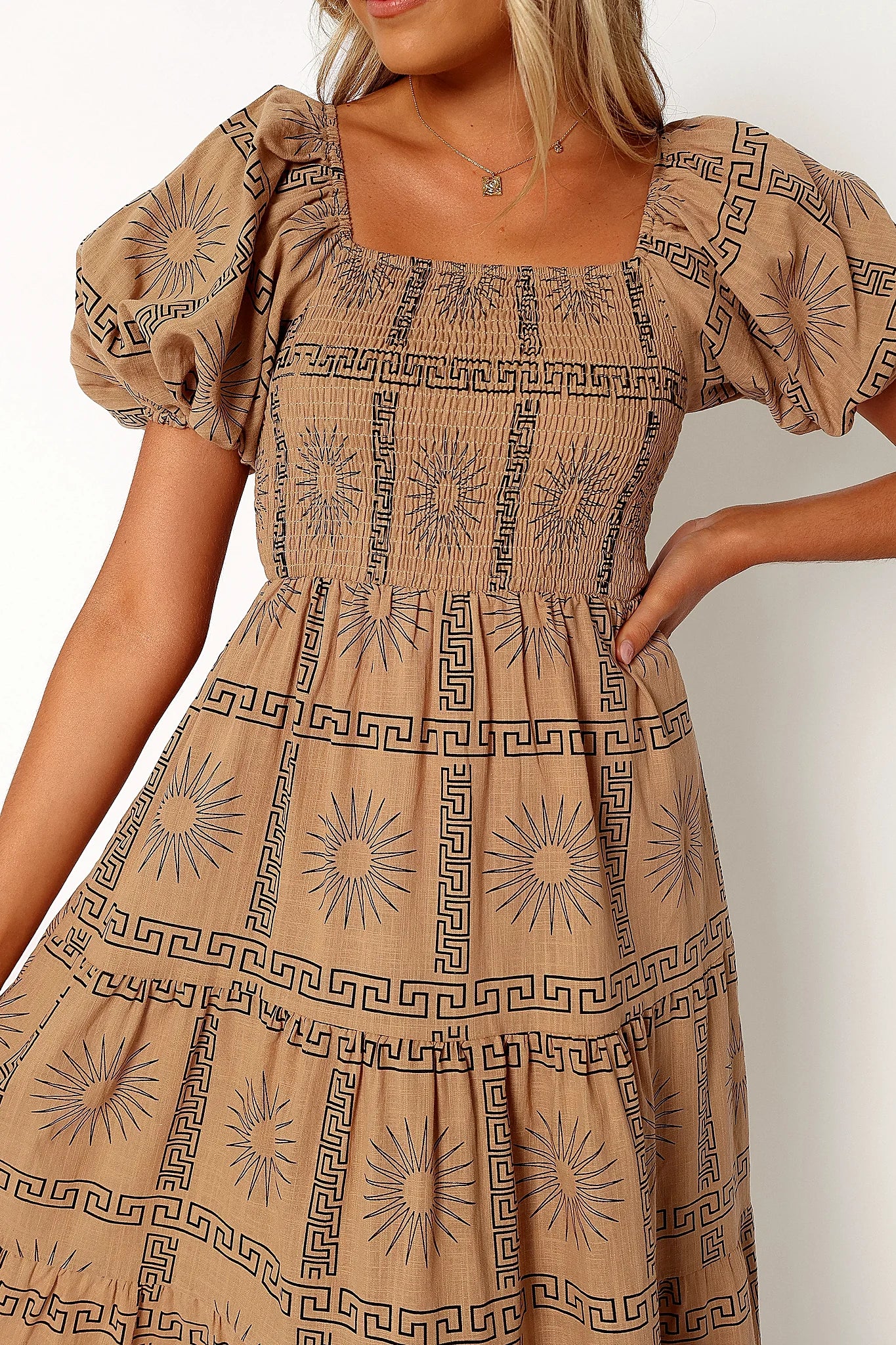Front view of a black tan & black sun print midi dress, showing the fit and drape of the skirt
