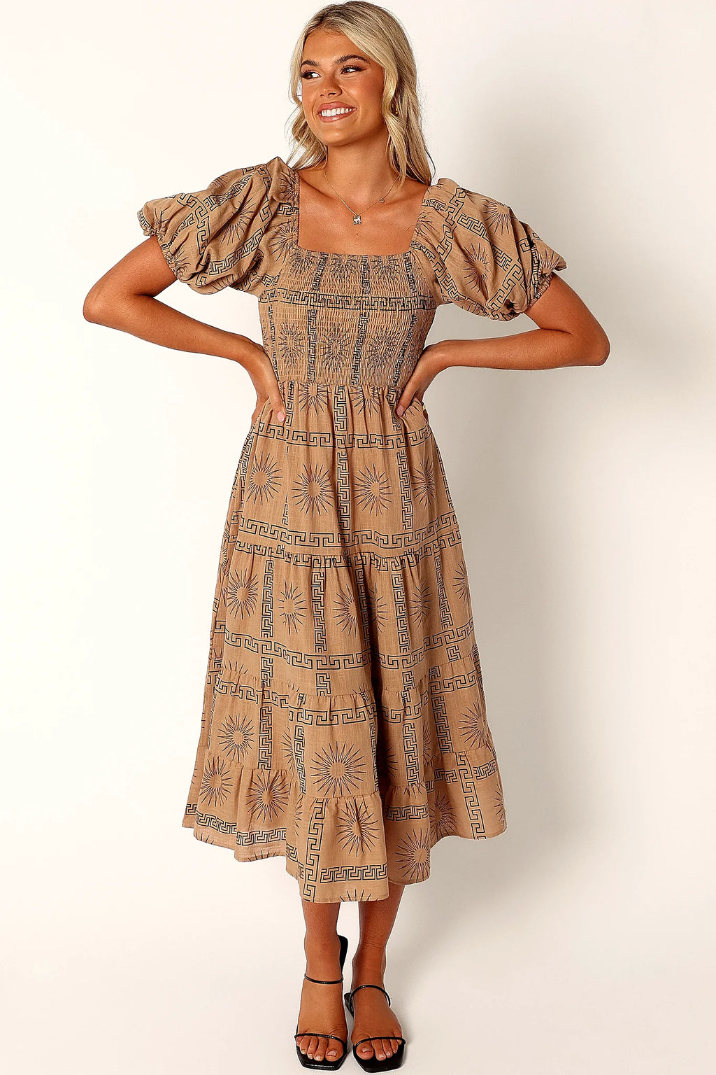 Side view of a black tan & black sun print midi dress, showing the fabric and hem finish