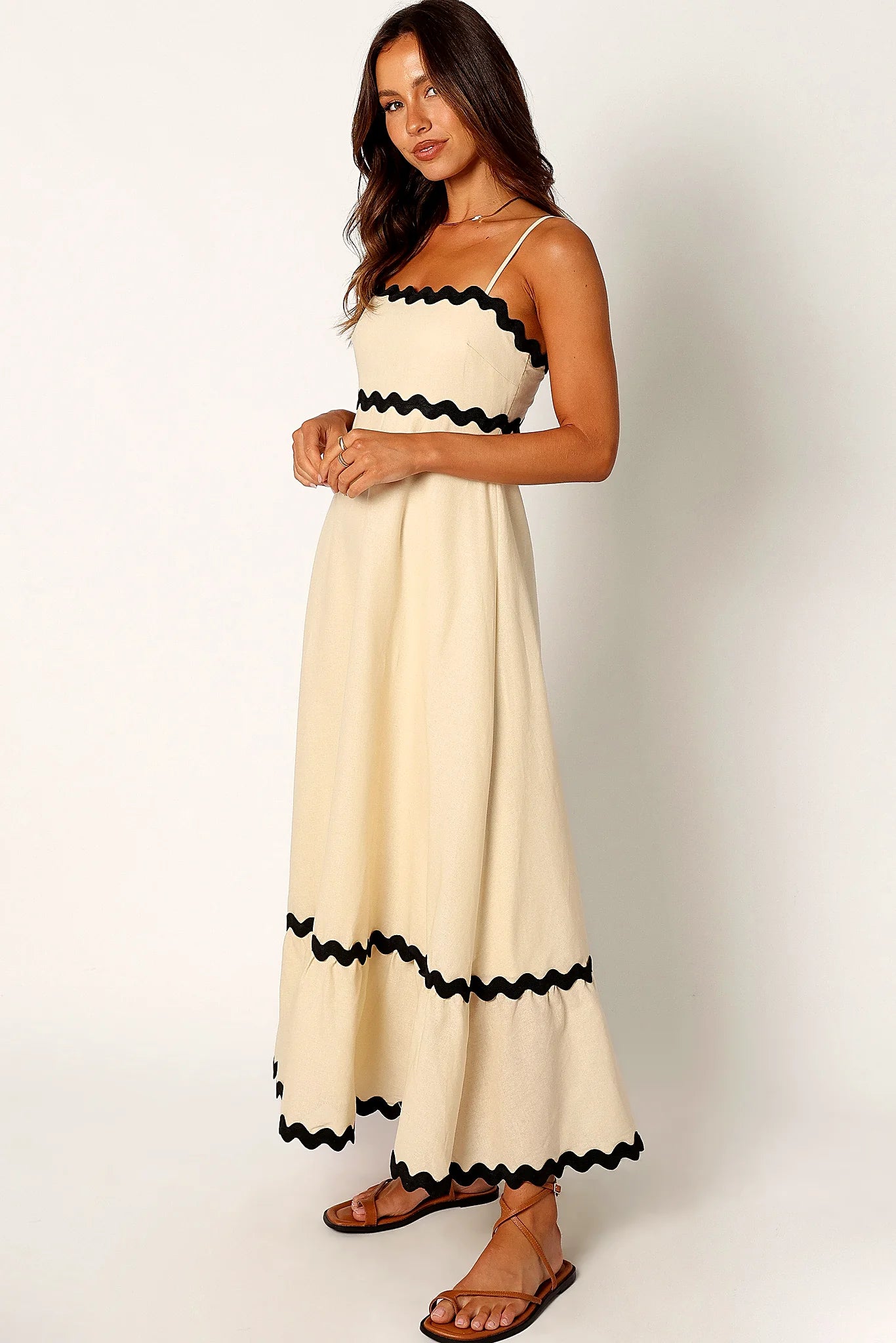 Front view of a black cream & black relaxed maxi dress, worn by a model against a plain studio backdrop
